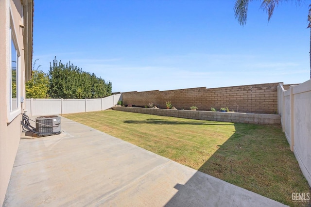 view of yard featuring a patio, central AC unit, and a fenced backyard