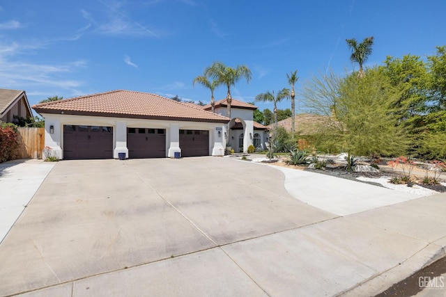 3121 Emerald Arbor St, Bakersfield, CA 93314 - view of front of house featuring a tile roof, stucco siding, a garage, and concrete driveway