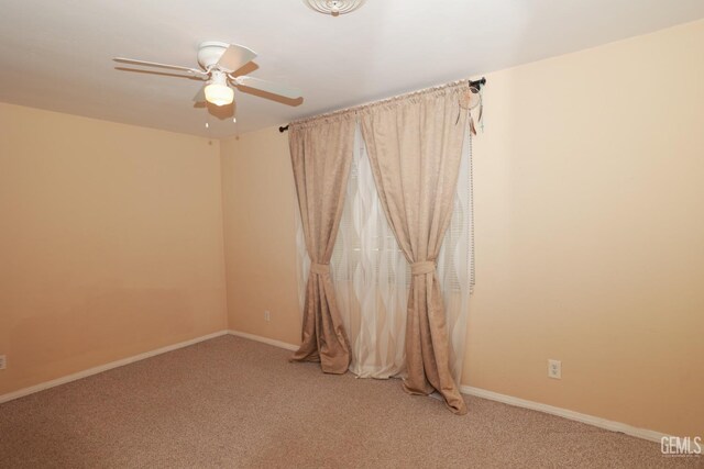 spare room featuring carpet floors and ceiling fan