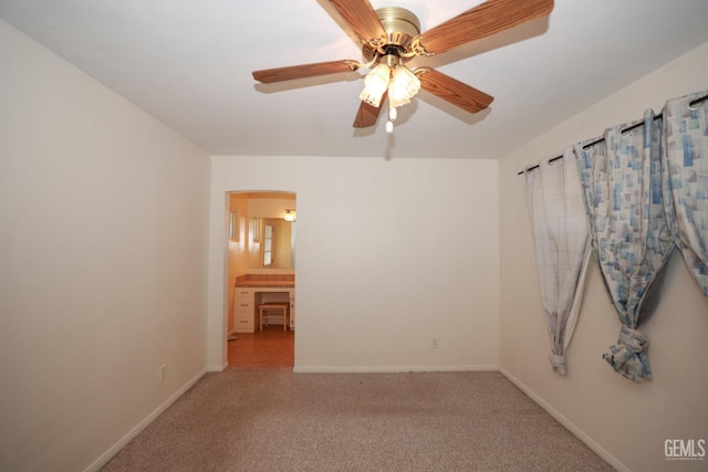 spare room with light colored carpet and ceiling fan