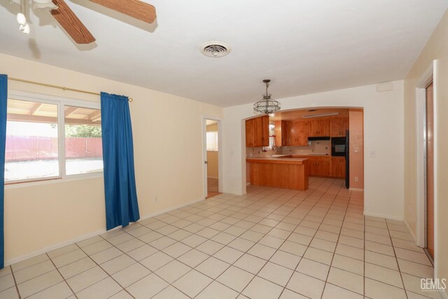 kitchen featuring pendant lighting, refrigerator, ceiling fan, light tile patterned flooring, and kitchen peninsula