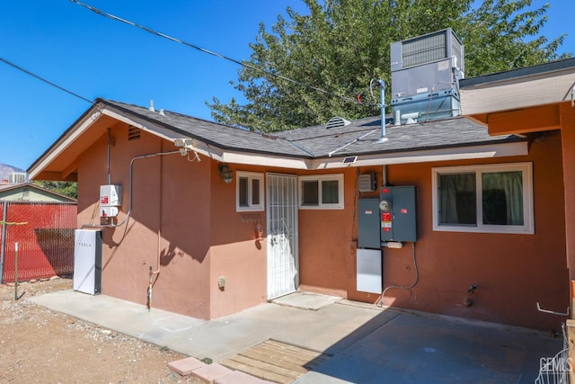 rear view of house featuring central air condition unit and a patio