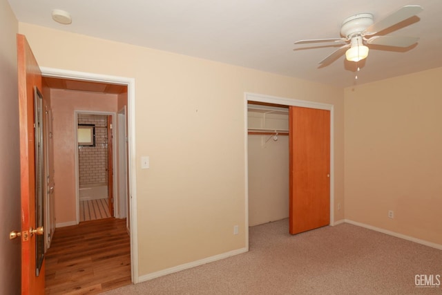 unfurnished bedroom with carpet flooring, ceiling fan, and a closet