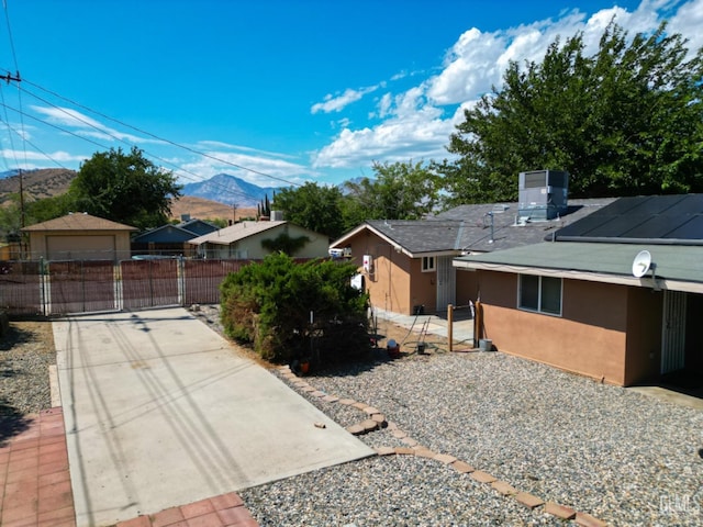 view of front of house featuring a mountain view and central AC unit