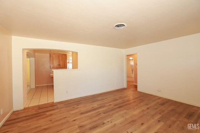 spare room with light hardwood / wood-style floors