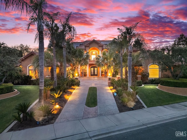 4905 Islands Dr, Bakersfield, CA 93312 - mediterranean / spanish-style home featuring french doors, curved driveway, a front lawn, and stucco siding