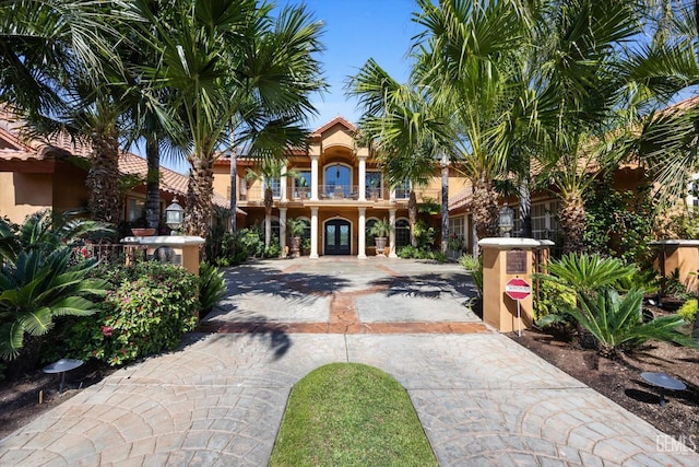 4905 Islands Dr, Bakersfield, CA 93312 - view of front of home with french doors, stucco siding, driveway, and a balcony