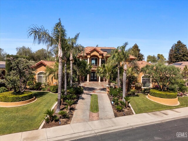4905 Islands Dr, Bakersfield, CA 93312 - mediterranean / spanish house with concrete driveway, a front lawn, french doors, and a tile roof