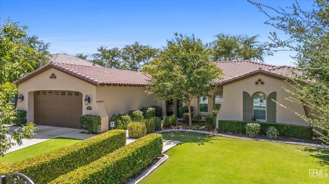 mediterranean / spanish-style home with a garage and a front lawn