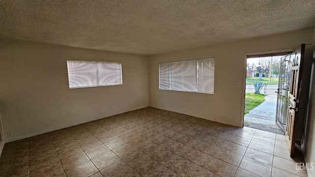 unfurnished room with a textured ceiling