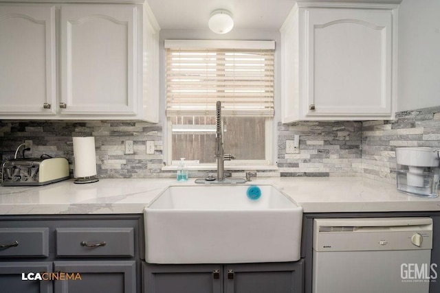 kitchen with a sink, gray cabinets, white cabinetry, and white dishwasher