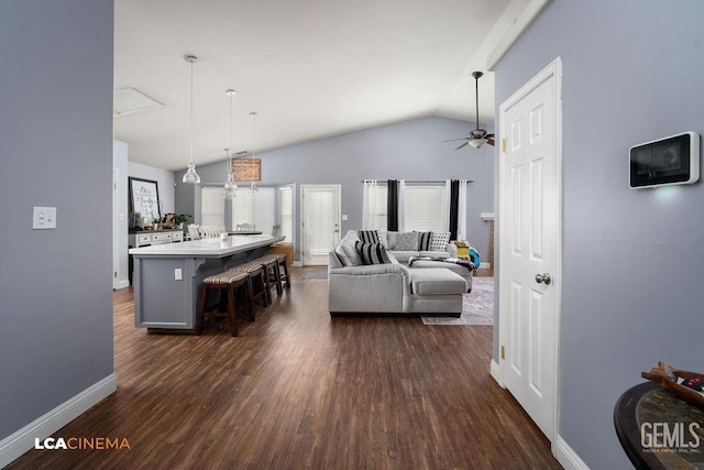 living room featuring dark wood-style floors, baseboards, lofted ceiling, and a ceiling fan