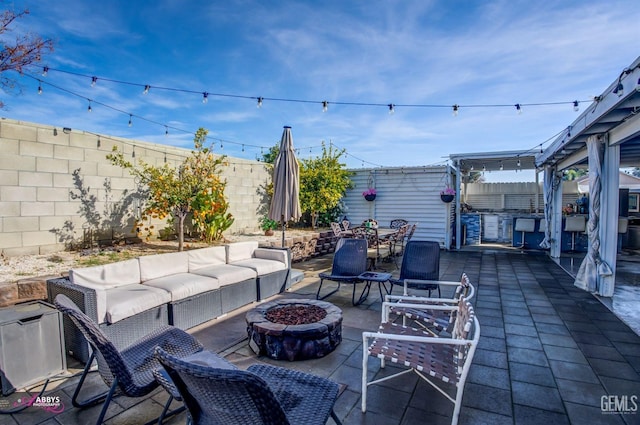 view of patio / terrace with an outdoor living space with a fire pit