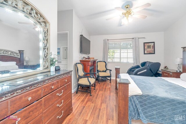 bedroom with lofted ceiling, ceiling fan, and light wood-type flooring