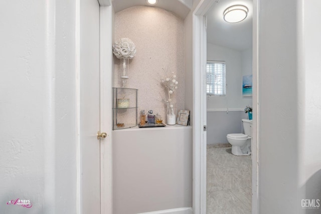 bathroom with vaulted ceiling and toilet