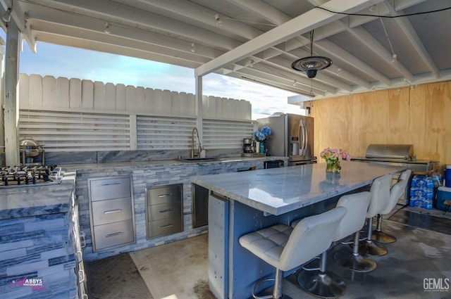 view of patio / terrace featuring an outdoor kitchen and sink