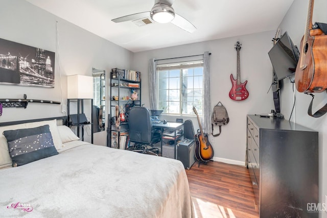 bedroom with dark hardwood / wood-style flooring and ceiling fan