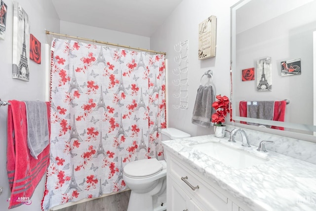 bathroom with vanity, hardwood / wood-style flooring, toilet, and a shower with shower curtain