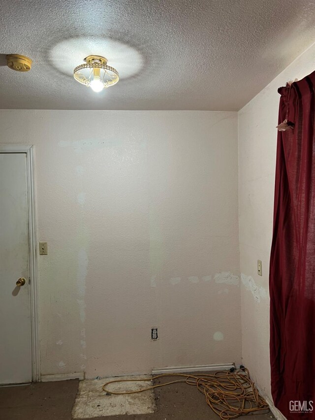 bedroom with a textured ceiling and carpet