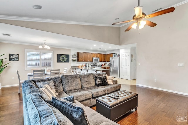 12503 Maclure Dr, Bakersfield, CA 93311 - living area with a chandelier, wood finished floors, a ceiling fan, and ornamental molding