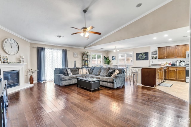 12503 Maclure Dr, Bakersfield, CA 93311 - living area featuring hardwood / wood-style floors, vaulted ceiling, a ceiling fan, a glass covered fireplace, and ornamental molding