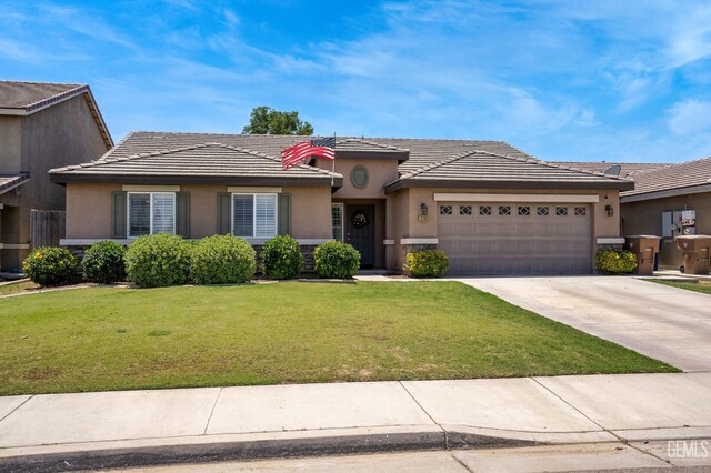 12503 Maclure Dr, Bakersfield, CA 93311 - view of front facade featuring an attached garage, stucco siding, a front yard, concrete driveway, and a tiled roof