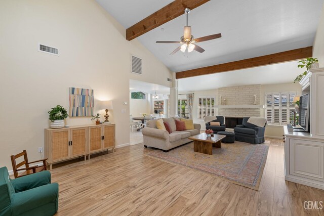 2700 Hoad Ln, Bakersfield, CA 93309 - living area with light wood-type flooring, beam ceiling, ceiling fan, a fireplace, and high vaulted ceiling