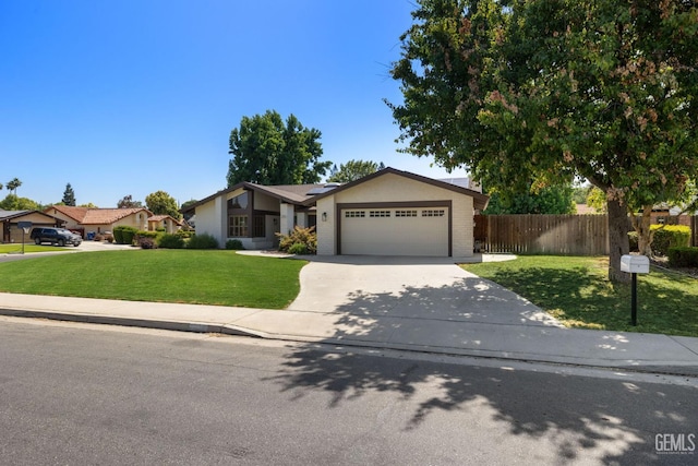 2700 Hoad Ln, Bakersfield, CA 93309 - view of front of house featuring an attached garage, driveway, and roof mounted solar panels
