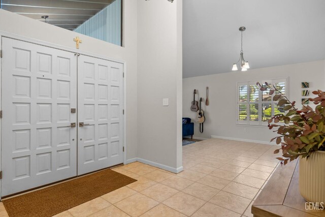 2700 Hoad Ln, Bakersfield, CA 93309 - foyer entrance featuring light tile patterned flooring, baseboards, a chandelier, and high vaulted ceiling