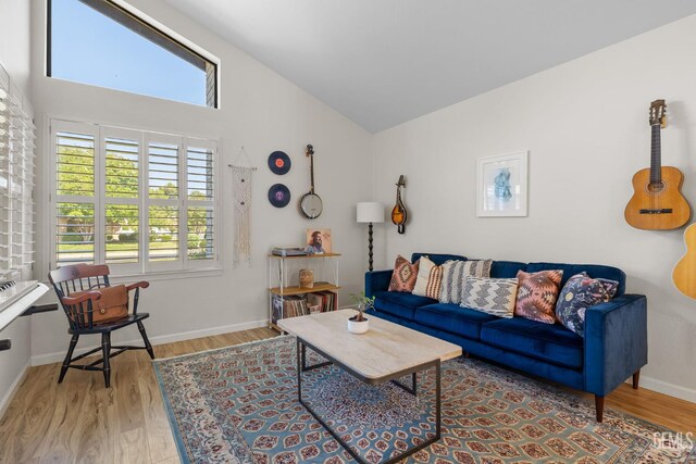 2700 Hoad Ln, Bakersfield, CA 93309 - living room with wood finished floors, high vaulted ceiling, and baseboards