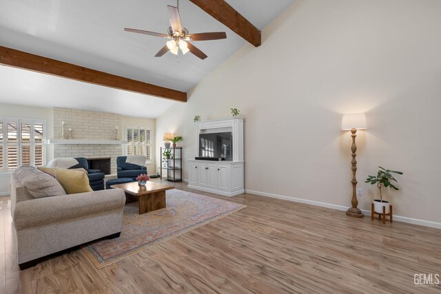 2700 Hoad Ln, Bakersfield, CA 93309 - living area with light wood-style floors, beam ceiling, a fireplace, baseboards, and a ceiling fan