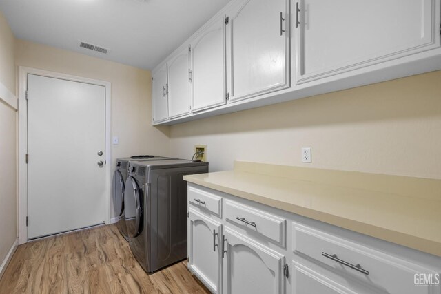 2700 Hoad Ln, Bakersfield, CA 93309 - laundry room with cabinet space, washing machine and clothes dryer, and light wood-type flooring