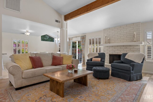 2700 Hoad Ln, Bakersfield, CA 93309 - living area with wood finished floors, plenty of natural light, a fireplace, and baseboards