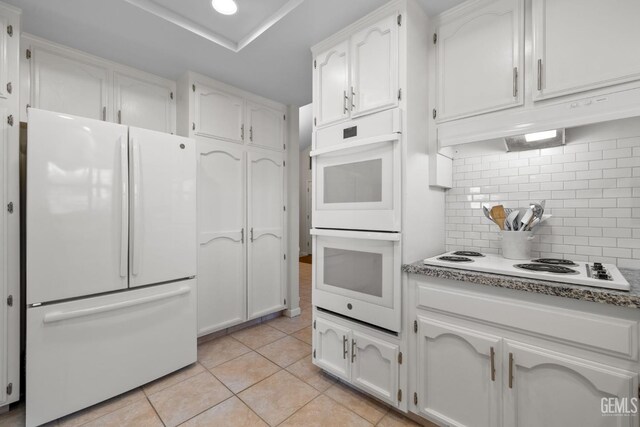 2700 Hoad Ln, Bakersfield, CA 93309 - kitchen featuring white appliances, white cabinetry, decorative backsplash, and light tile patterned flooring