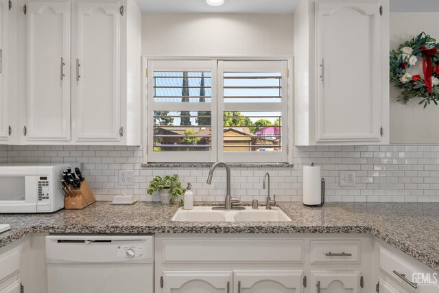2700 Hoad Ln, Bakersfield, CA 93309 - kitchen featuring white appliances, a sink, white cabinets, and backsplash