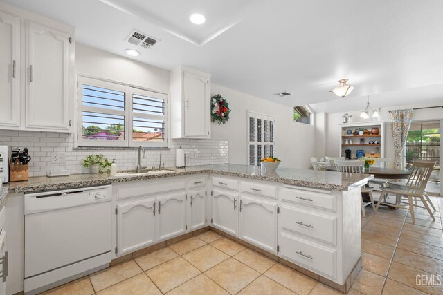 2700 Hoad Ln, Bakersfield, CA 93309 - kitchen with dishwasher, a sink, backsplash, a peninsula, and light tile patterned flooring