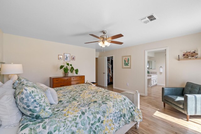 2700 Hoad Ln, Bakersfield, CA 93309 - bedroom featuring light wood finished floors, a spacious closet, baseboards, a closet, and ceiling fan