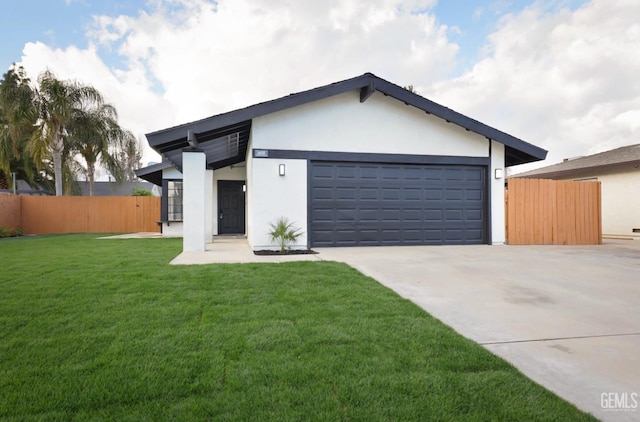 view of front of property featuring a garage, driveway, fence, a front lawn, and stucco siding