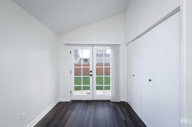 entryway with dark wood-type flooring, lofted ceiling, french doors, and baseboards