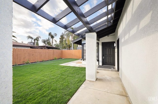 view of yard featuring fence, a patio, and a pergola