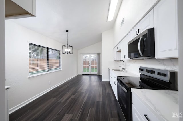 kitchen featuring dark wood finished floors, white cabinets, stainless steel electric range oven, a sink, and backsplash