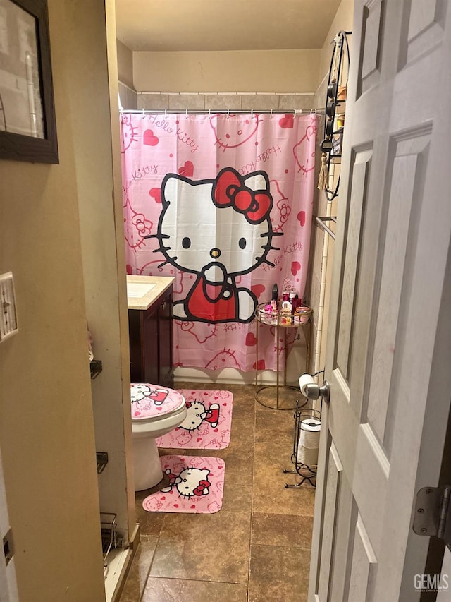 bathroom with vanity, a shower with shower curtain, and toilet