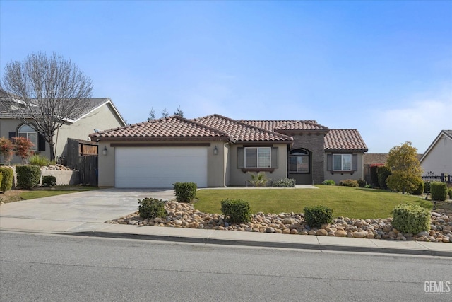 mediterranean / spanish house with an attached garage, a tile roof, driveway, stucco siding, and a front lawn