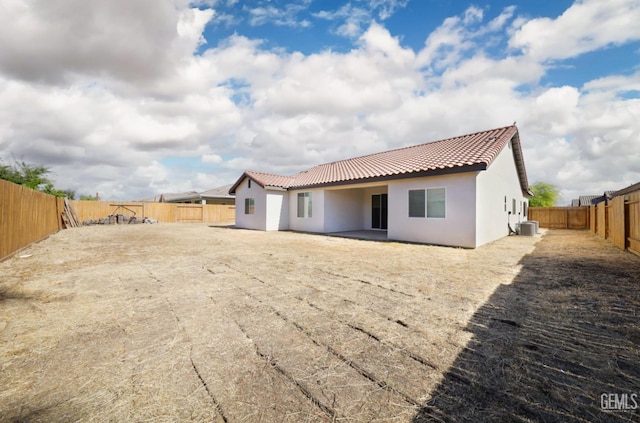 4414 Coal Rock Ct, Bakersfield, CA 93313 - rear view of property with a tiled roof, central AC unit, stucco siding, and a fenced backyard