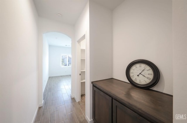 4414 Coal Rock Ct, Bakersfield, CA 93313 - hall featuring arched walkways, baseboards, and light wood-style flooring