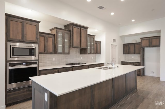 4414 Coal Rock Ct, Bakersfield, CA 93313 - kitchen featuring appliances with stainless steel finishes, a sink, dark brown cabinetry, decorative backsplash, and recessed lighting