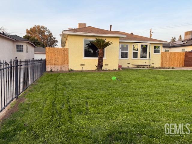 back of house with a lawn