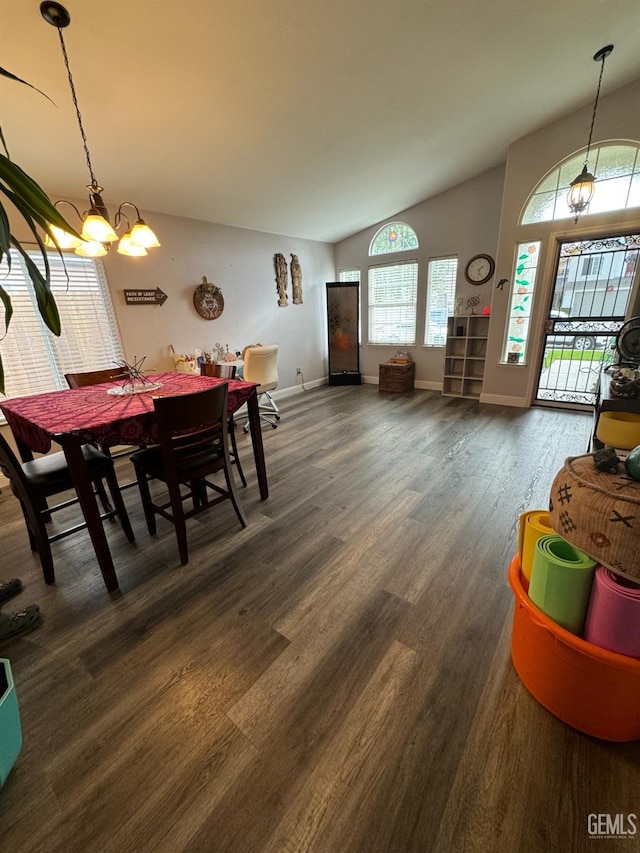 dining room featuring vaulted ceiling, dark hardwood / wood-style floors, and an inviting chandelier