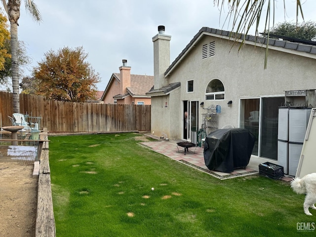 back of property featuring a yard and a patio