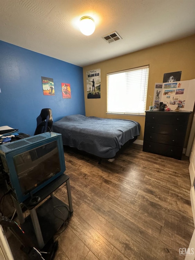 bedroom with dark wood-type flooring